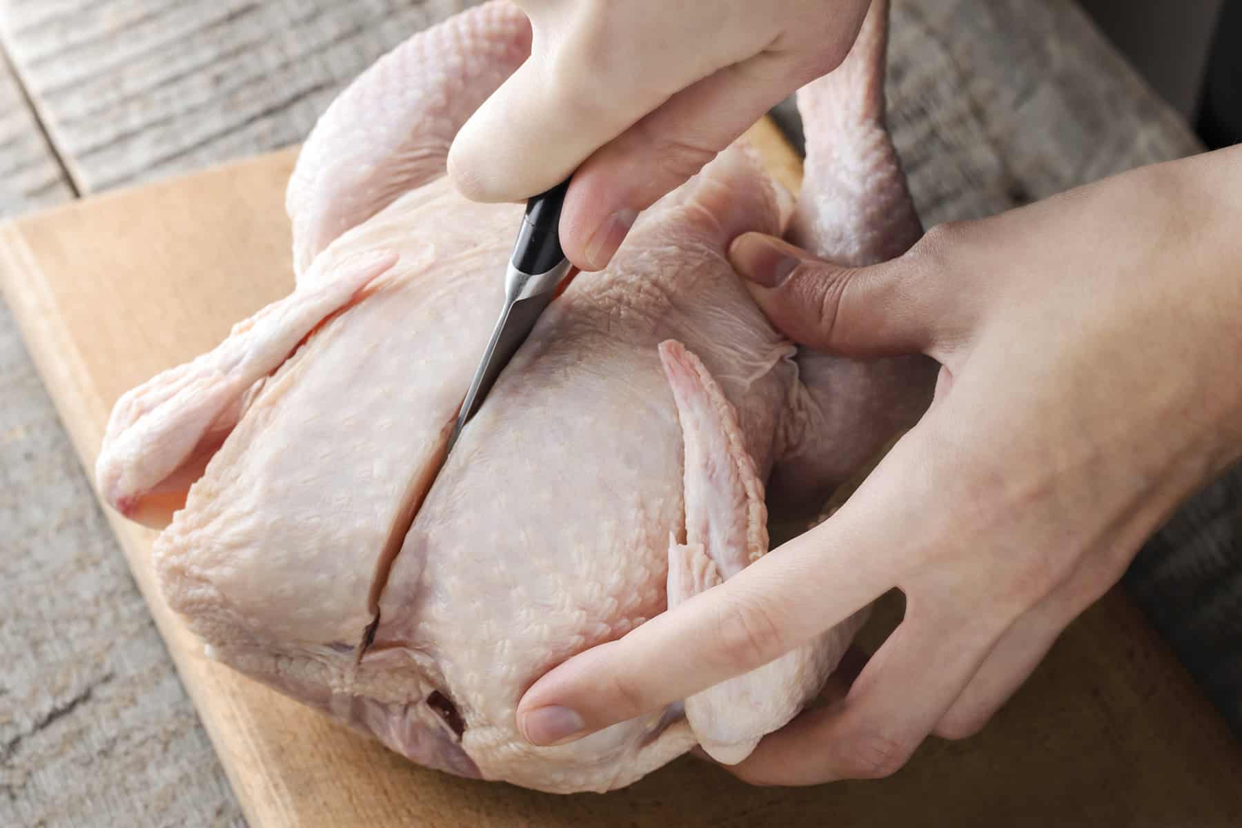 Cutting a whole chicken.