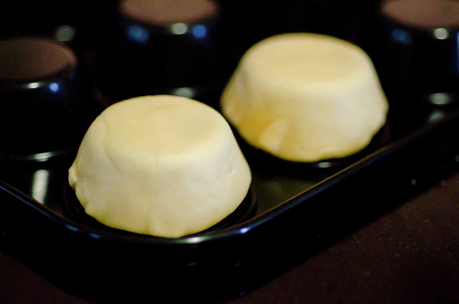 Pastry placed on the upside down muffin tins.