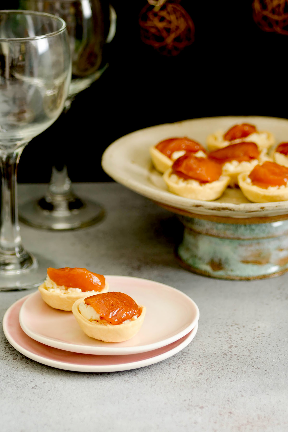 Mini tart shells filled with cheese and fruit.