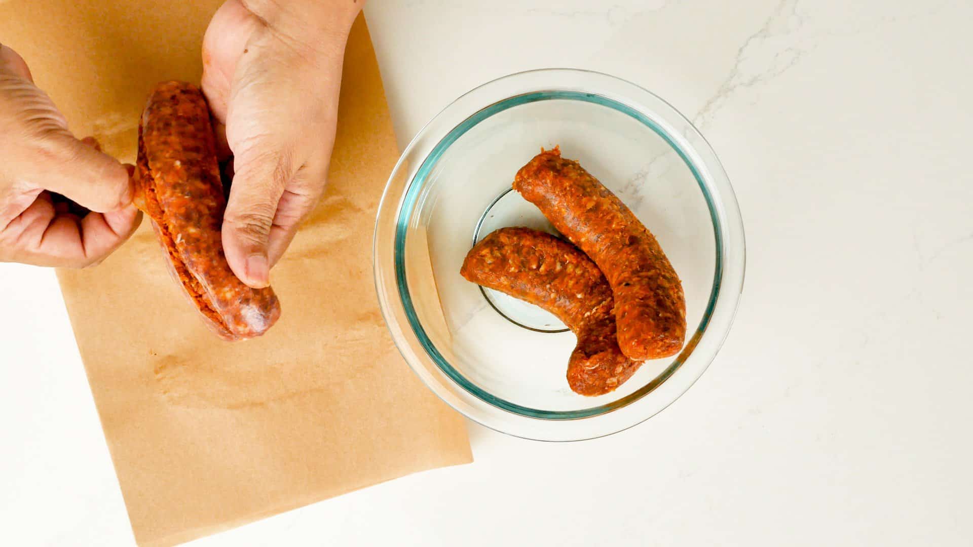 Removing casing from chorizo sausage.