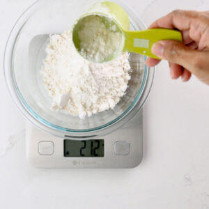 Measuring and weighing flour.