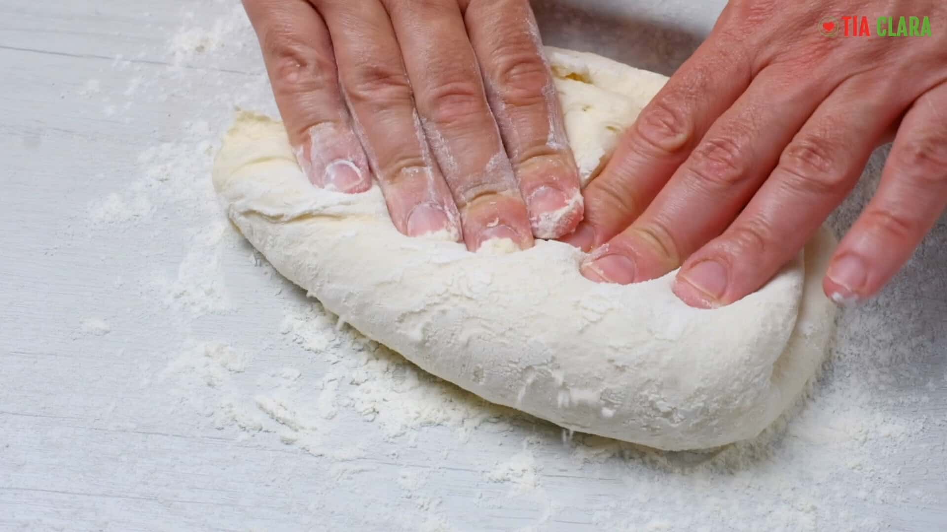 Pressing the dough.