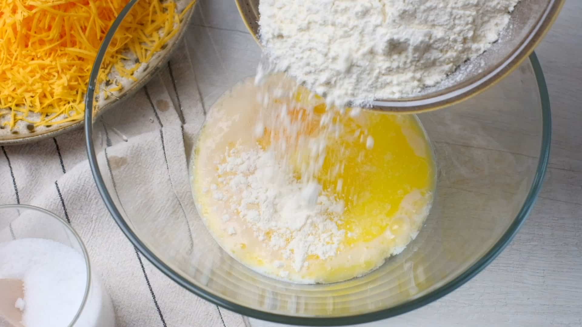 Adding flour to bowl.