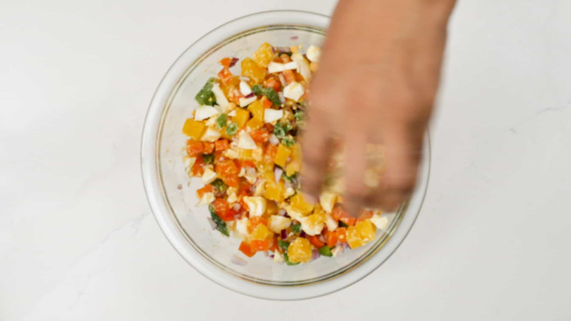 Mixing salad ingredients.