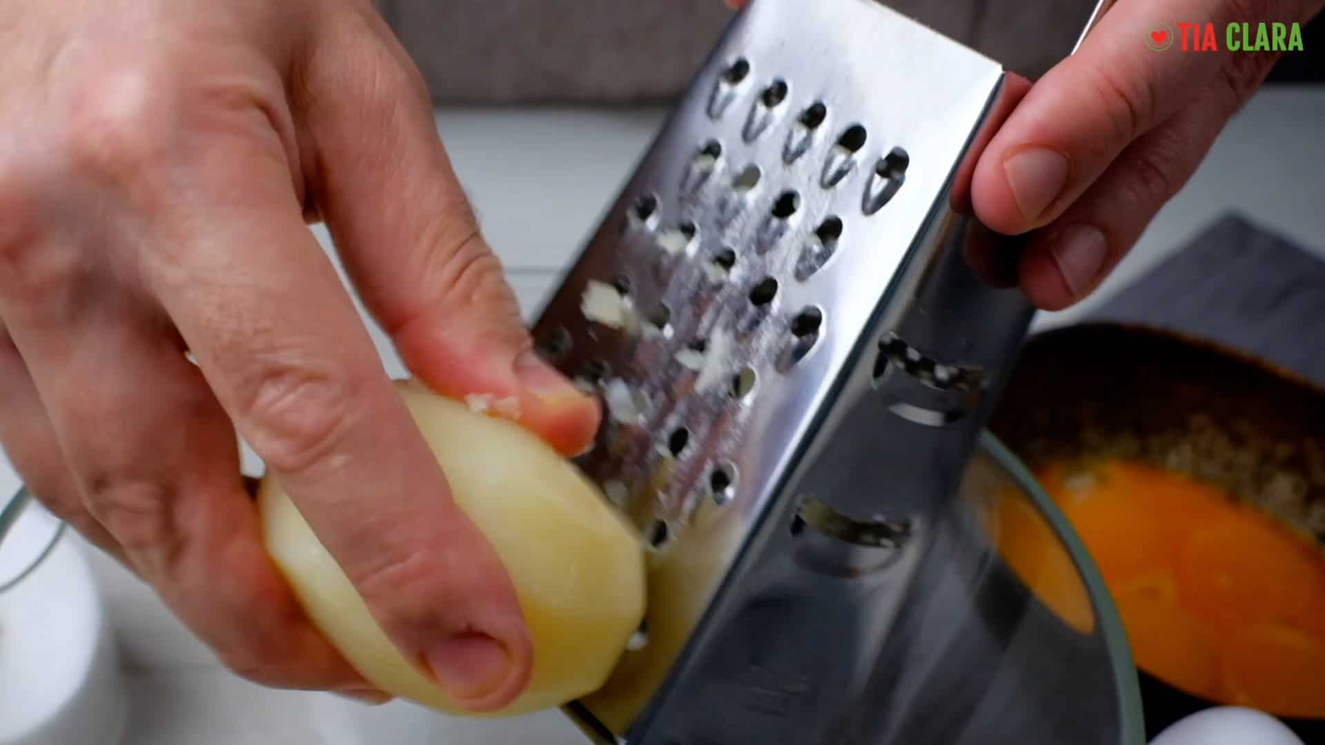 Grating the potatoes.