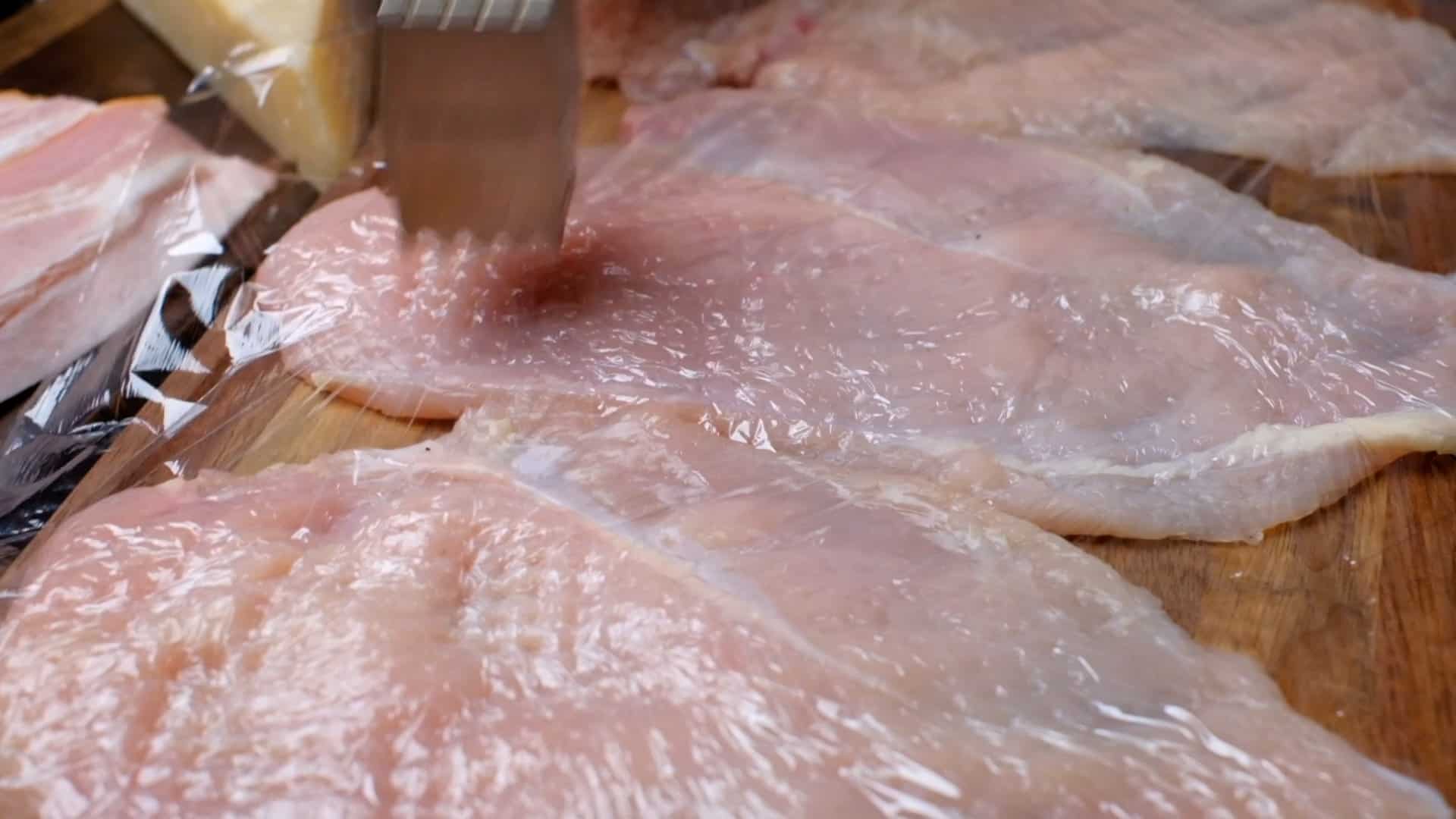 Flattening the chicken breasts.