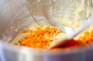 Folding carrot into batter.