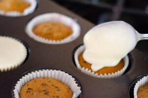 Icing the carrot cupcakes.