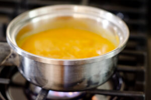 Reheating carrot soup.