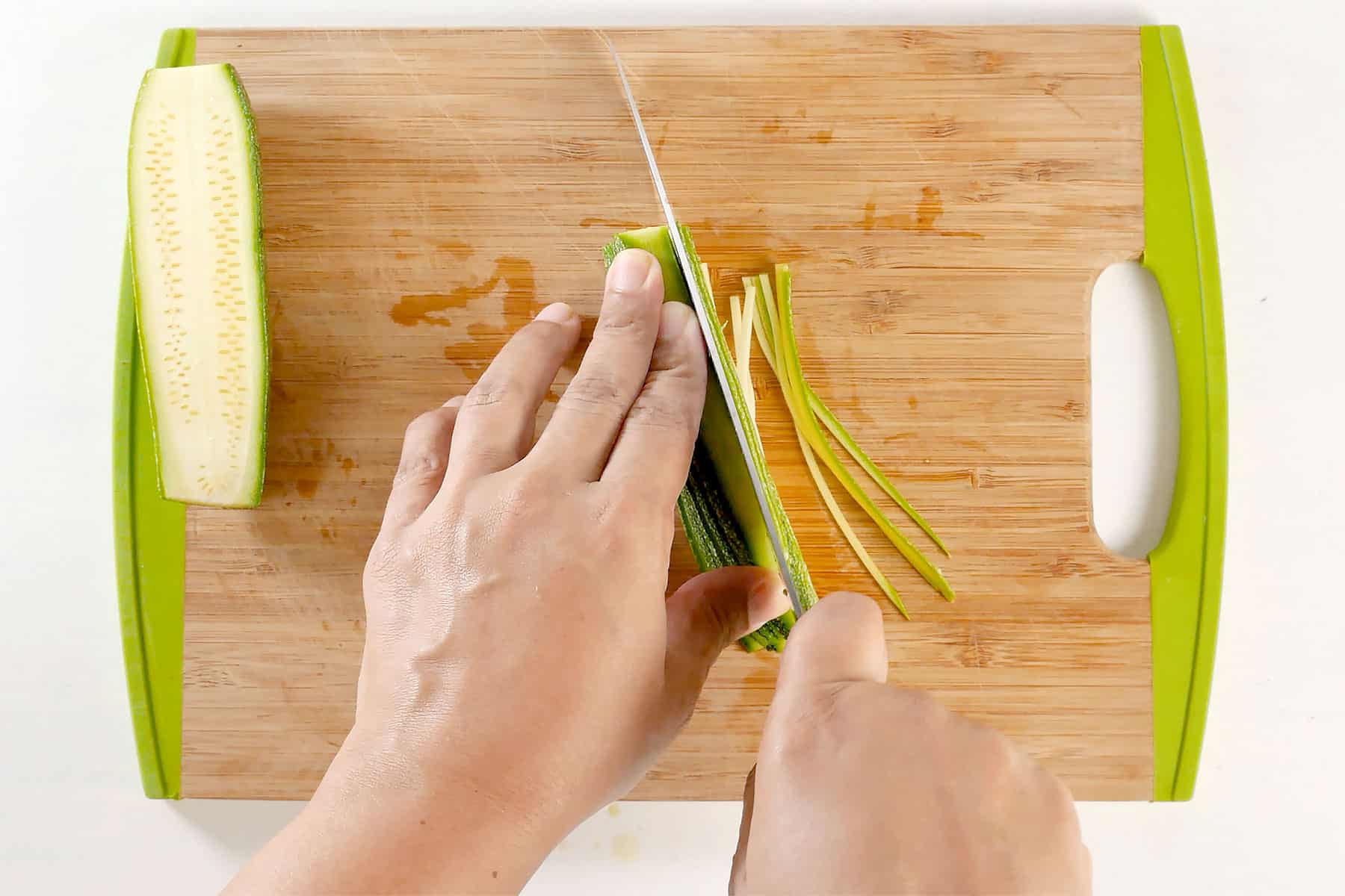 Chopping zucchini.