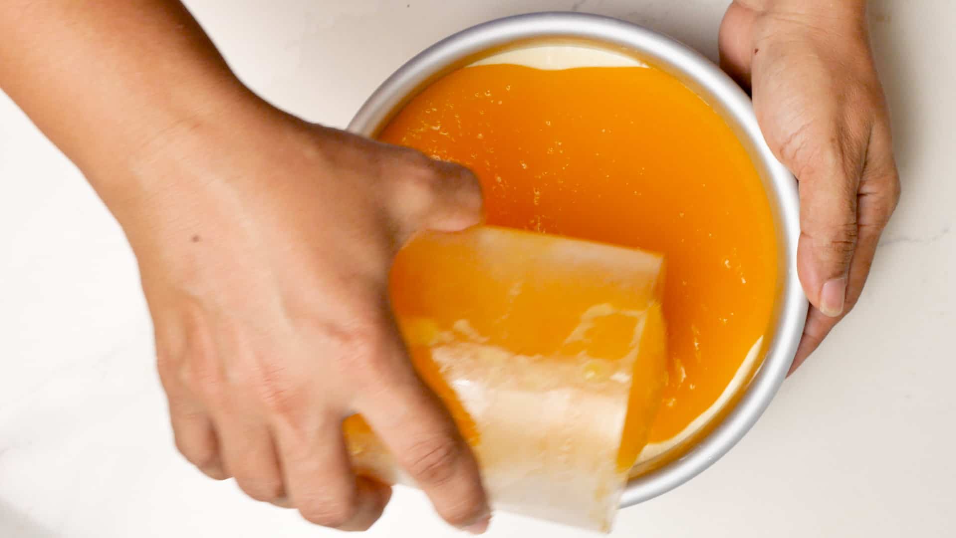 Pouring the mango jelly.