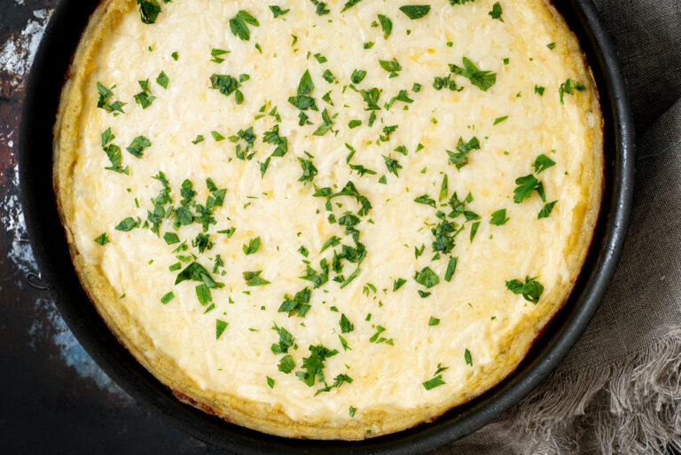 Queso plantain tart sprinkled with parsley.