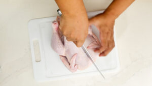Cutting the chicken.