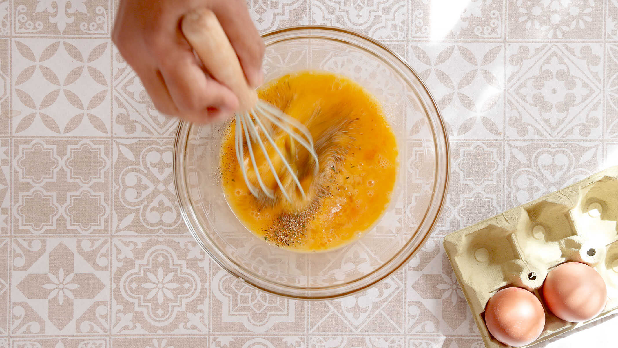 Whisking the eggs.