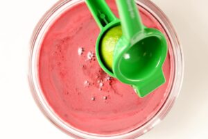 Squeezing lime into beet carrot juice.